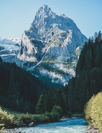 Giant rocky mountain at the end of a river.